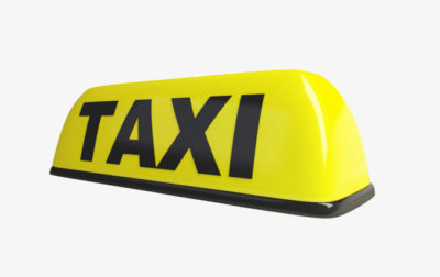 Small yellow taxi sign often displayed atop taxicabs world wide to make the cabs stand out from other cars.